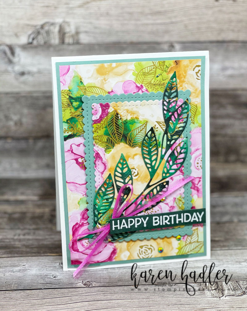 Highlighting the Expressions in Ink DSP. This happy Birthday card has a gorgeous paper with water coloured flowers in polished Pink and Pale Papaya. There is also green water coloured shapes inter-dispersed and gold leaves throughout. The DSP covers the front of the card but has a layers pop up in the middle. the large leaf die is also cut out of the stunning DSP a deep green colour and sweeps from the bottom to top on the right hand side. There is a bow in Lovely Lipstick and white embossed on a strip of Evening Evergreen is Happy Birthday.