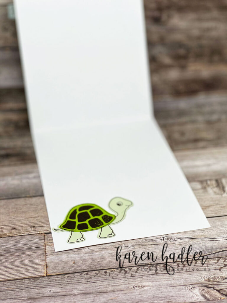 happy Birthday Turtle Friends inside a white card with a green turtle in the bottom left hand corner.