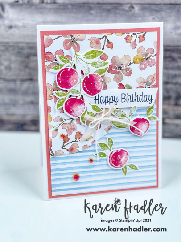Sweet AsA Peach card on a thick white Card base. A calypso Coral mat. The You're a Peach DSP is ripped in half to highlight both sides. There are 5 red/orange peaches with Pear Pizzaz Green leaves. The Sentiment is stamped in Black on Basic White and reads Happy Birthday.
