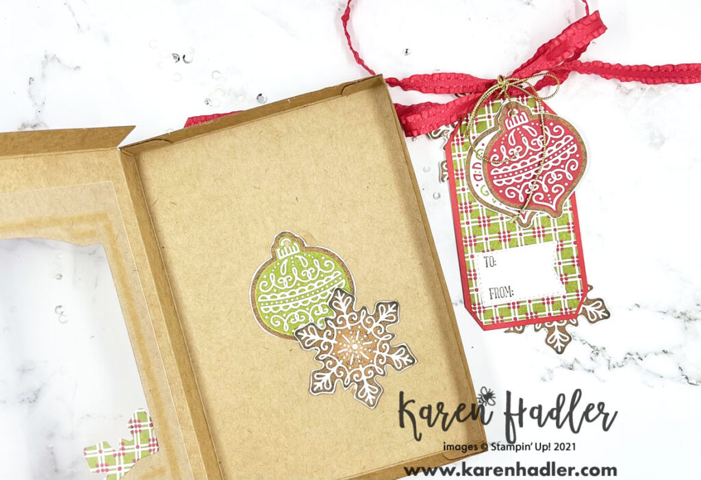 The inside of the Kraft Gift box showing two elements adhered to the inside a large green bauble and a large snowflake.