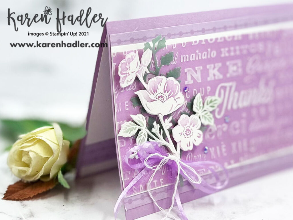 Fresh freesia Thank You card. Looking at the card at a different angle and you can see the Co-ordinating DSP strip inside.A Fresh Freesia Card base with a large strip of Fresh Freesia Shimmer Vellum  across the front that has been embossed with Thank you's in many different languages. The large Thanks has been coloured the Whitest. To the left is a posy of Fresh freesia Flowers that have been white embossed and water coloured.. Around this posy is a Fresh Freesia bow with white twine. 