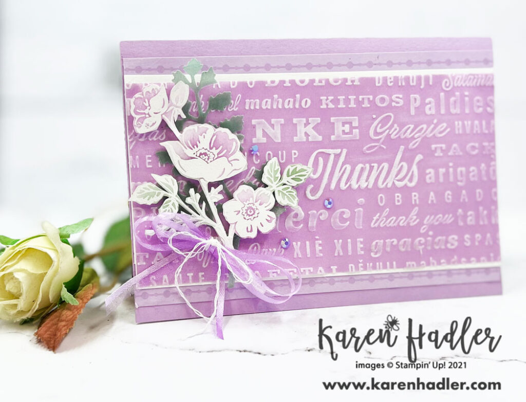 Fresh freesia Thank You card. A Fresh Freesia Card base with a large strip of Fresh Freesia Shimmer Vellum  across the front that has been embossed with Thank you's in many different languages. The large Thanks has been coloured the Whitest. To the left is a posy of Fresh freesia Flowers that have been white embossed and water coloured.. Around this posy is a Fresh Freesia bow with white twine. 