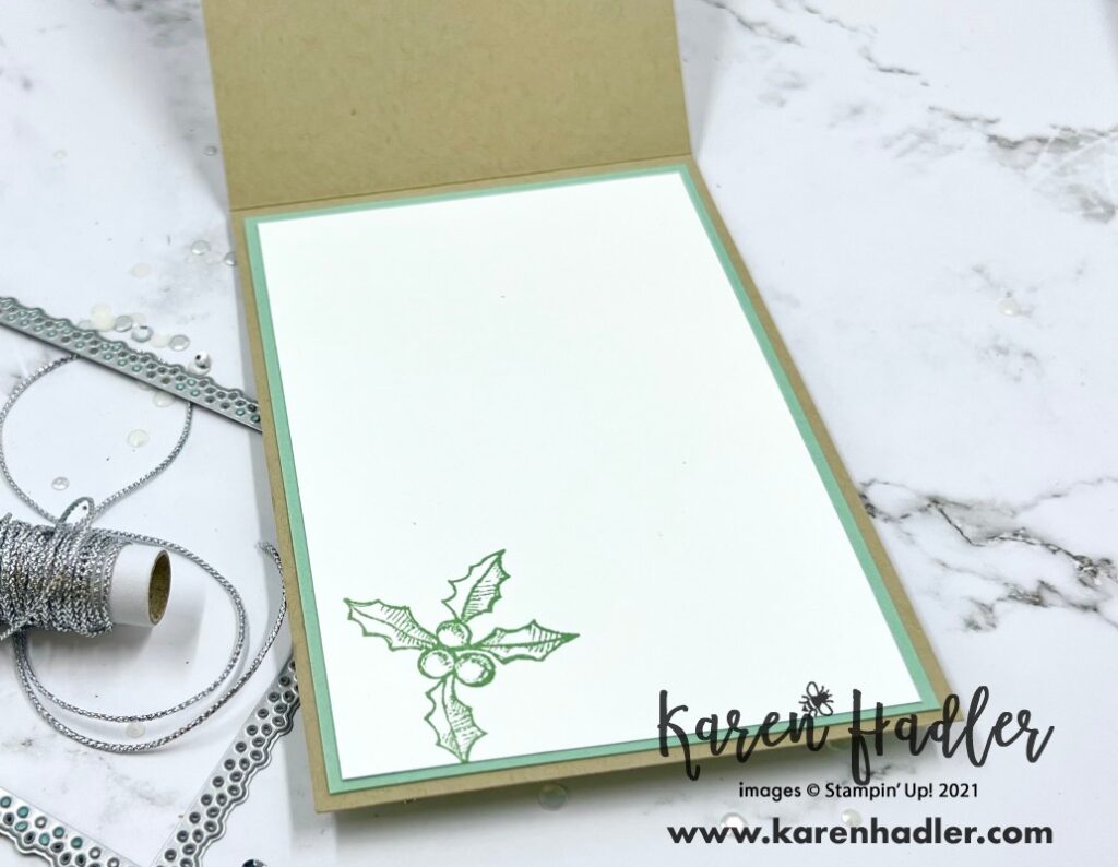 Happy Holly-Days crumb cake card inside. There is a Mint Macaroon mat with Holly stamped on the bottom  left hand corner of a White Mat which is also stamped in Mint Macaroon. 