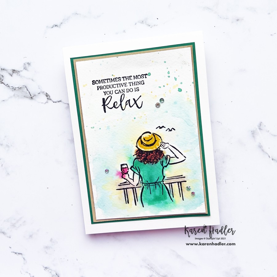 A picture of a card that is water coloured with a girl looking out to sea on a sunny day. She has a green dress and yellow hat. The txt says sometimes the most productive thing you can do is relax.
