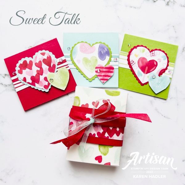 A picture of bright coloured small square gifts cards. Red Blue and Green all with Large hearts in the middle and a smaller one bottom right hand corner. These cordinate with the small gift box which has a red and blue ribbon tied in a bow around it.