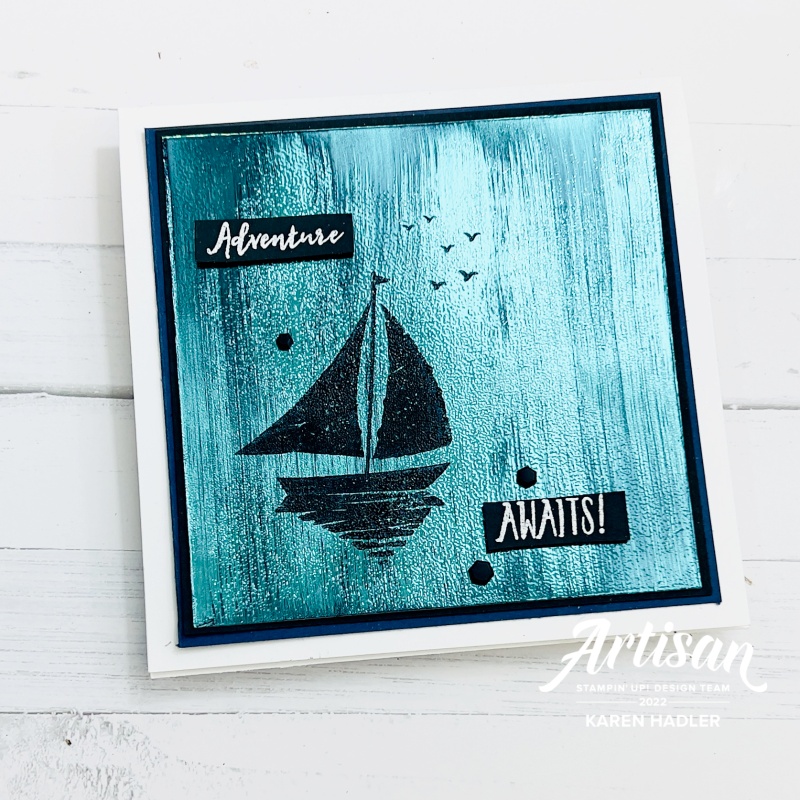 A blue masculine shimmery blue card with sail boat and says adventure awaits.