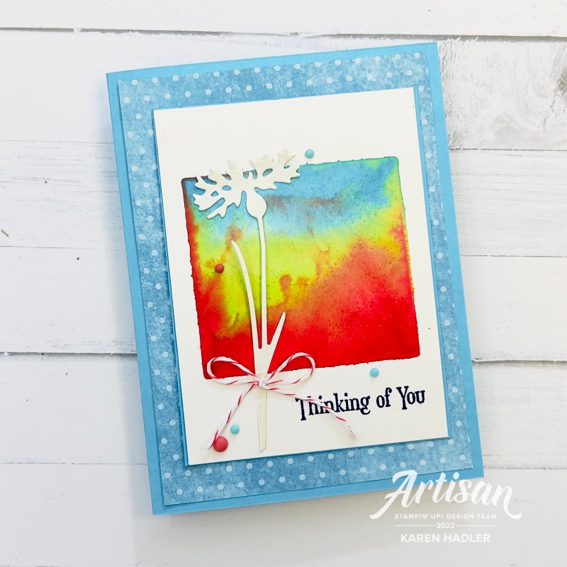 A greeting card thinking of you with bright happy water colours and a flower and polka dot background.