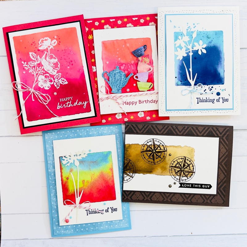 five greeting cards with water coloured backgrounds in a multitude of colours.