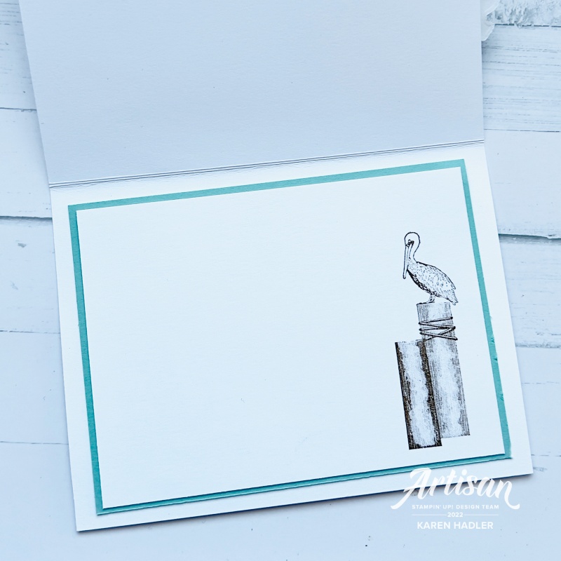 Inside a greeting card with a shag sitting atop a post.