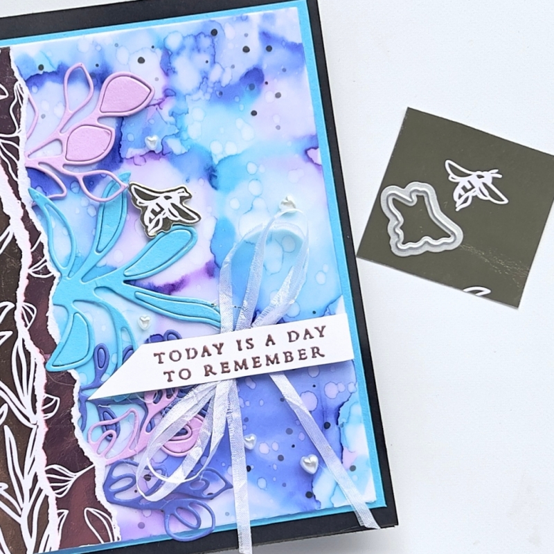 A picture of a card showing the Isopropyl Alcohol and Blends background bright and unique with purples and pinks. The sentiment reads Today is a day to remember.