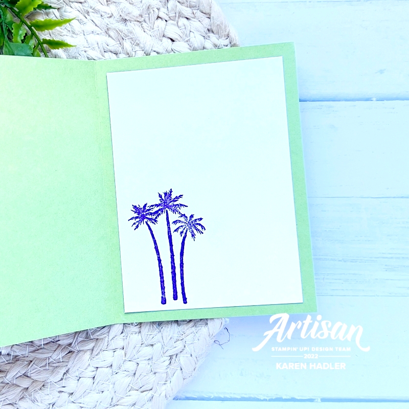 A picture of the inside of a green greeting card with 3 small palm trees stamped.