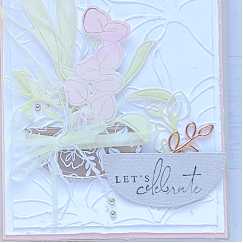 A close up  picture of a Let's Celebrate a Splendid Day Greeting Card in soft greens, pinks and white. There are long stemmed leaves and flowers.