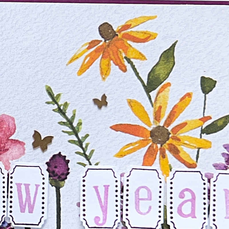 A close up look at the Daint Flowers Designer Series Paper with 2 watercolour Yellow daisies. 
