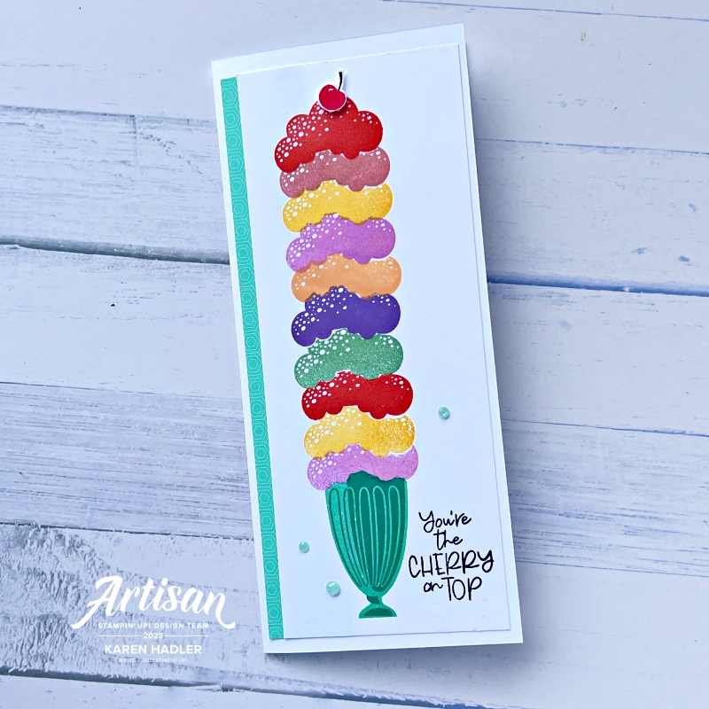 A picture of a Greeting Card that is slim line on the front is an super sized icecream sundae with many colourful scoops of icecream