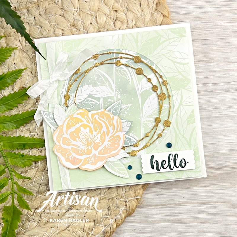 A greeting Card that says Hello with a gold circle with small gold circles around the middle. There is a large flower and leaves on the edge of the circle.