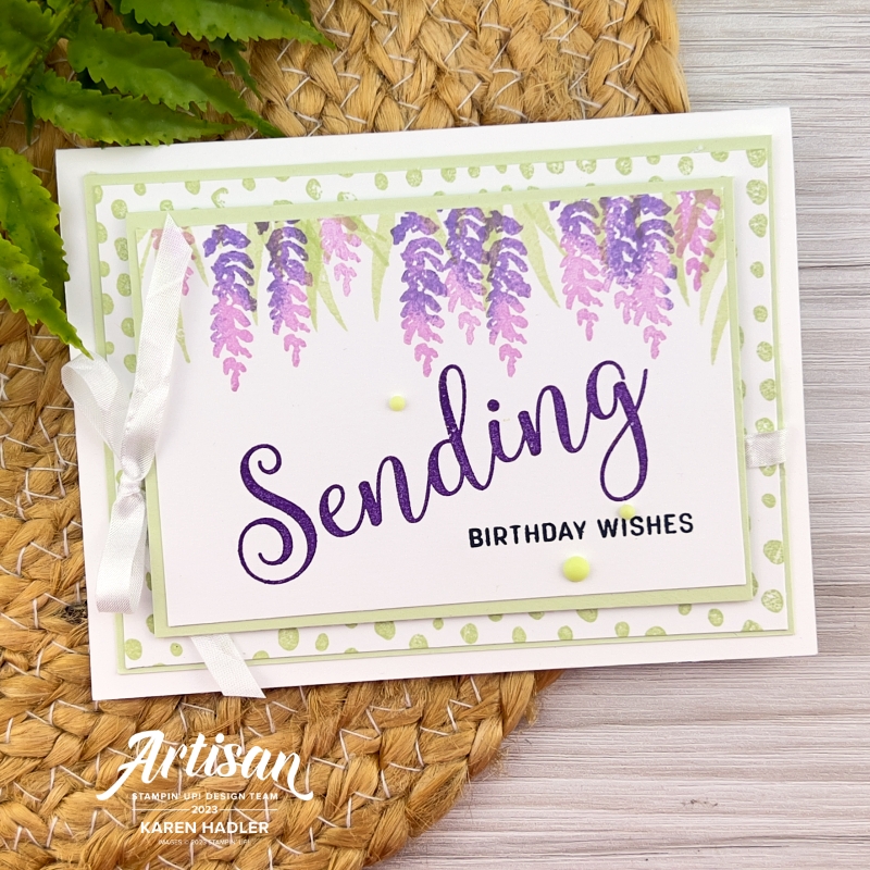 A picture of a greeting card with a Soft Sea Foam Dotty back ground and purple Wisteria hanging down with green leaves. The sentiment reads Sending Birthday Wishes.