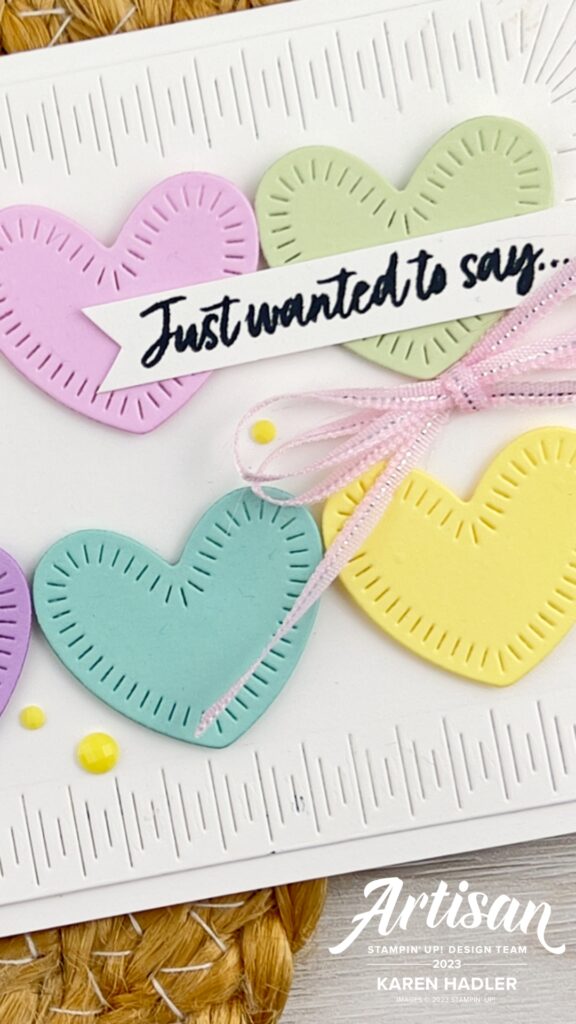 A close up of aA white greeting card with stitching around the border. Inside is pastel hearts , Petal Pink. bubblebath, lemon Lolly, Soft sea foam, pool party and  fresh freesia. The sentiment reads I just wanted to say ...