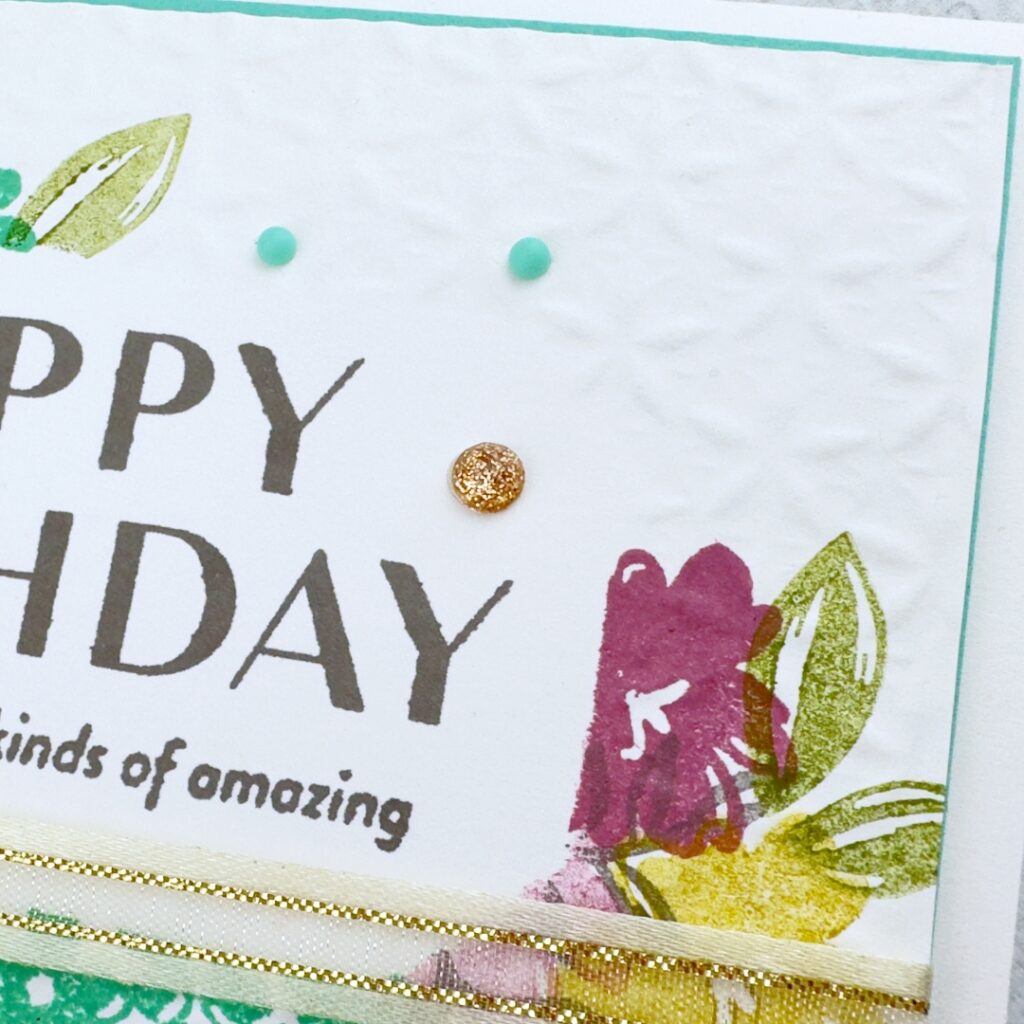 A close look at partial embossing on white card stock.