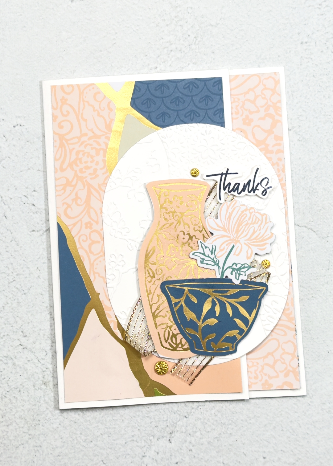 A thank you card with pinks and blues Japanese style. The is a patterned vase and cup and flowers on top of some beautiful patterned papers. This photo also shows the inside.