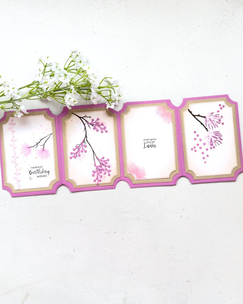 A Birthday card in layers of Pinks and Crumb Cake.The card has four panels On the front is two pink flowers on a branch with dots in the back ground. The second pink berries on a long branch, the 3rd words that read sent with lots of love and the fourth two 3d flowers coming off a branch from the top and some dots in the background.