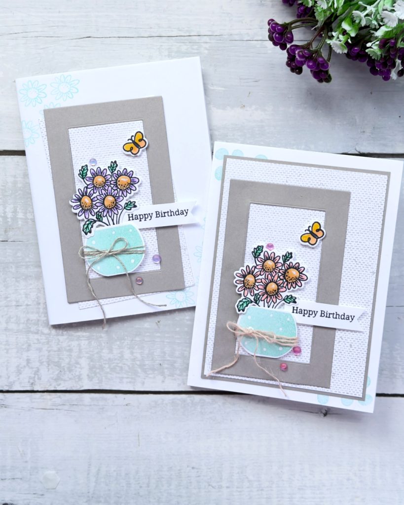 two greeting cards both with a linen look background a Gray granite Frame inside the frame is a vase with 3 purple flowers the sentiment reads happy Birthday