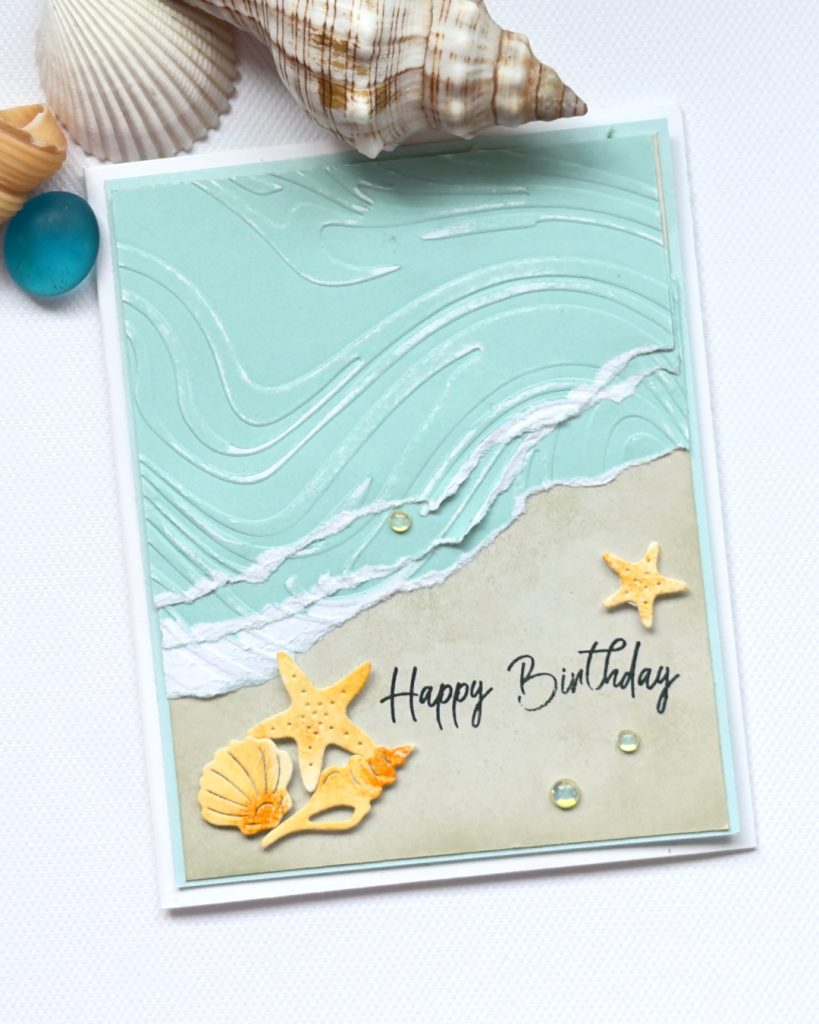 Beach birthday card made with Rolling Waves Bundle featuring embossed ocean waves, torn paper foam technique, ink blended sand, and die-cut shells and starfish.
