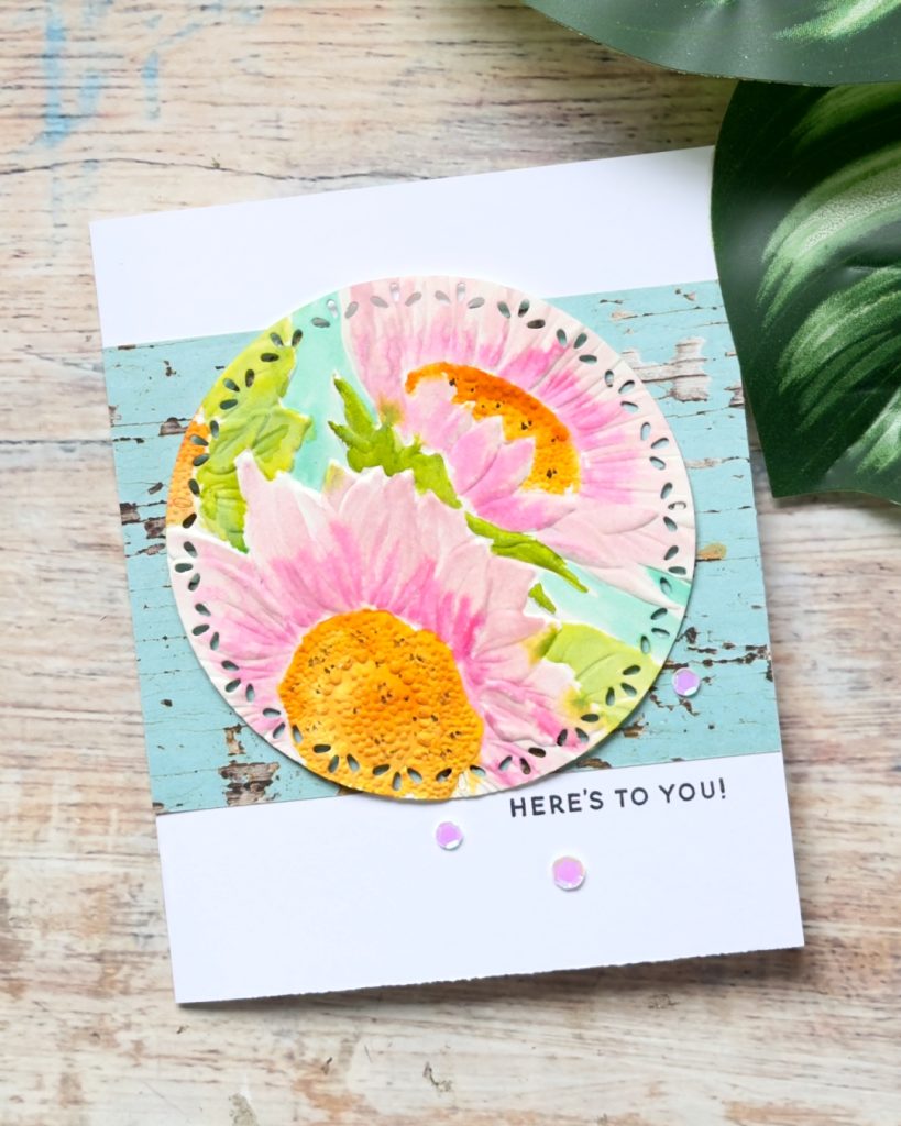 Handmade sunflower card embossed on watercolour paper and painted in soft pinks and yellows with a fresh, artistic finish.