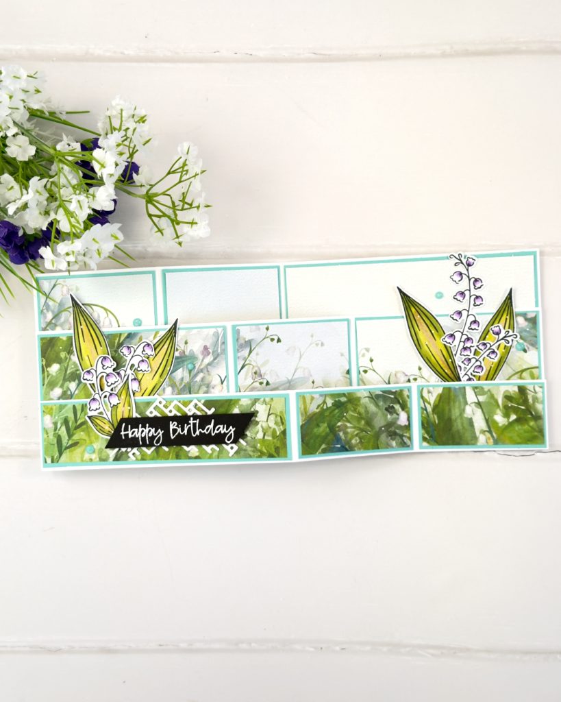 Double Z fold card fully opened showing layered panels with Valley in Bloom designer paper, lily of the valley die cuts, and dimensional floral details.