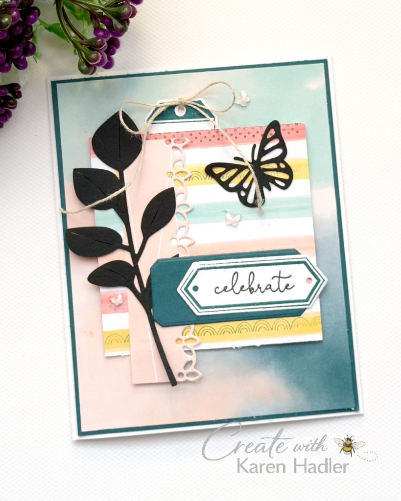 Handmade “Celebrate” card featuring soft blended teal background, layered striped designer paper, black butterfly and foliage die cuts, twine bow, pastel embellishments and layered sentiment label.