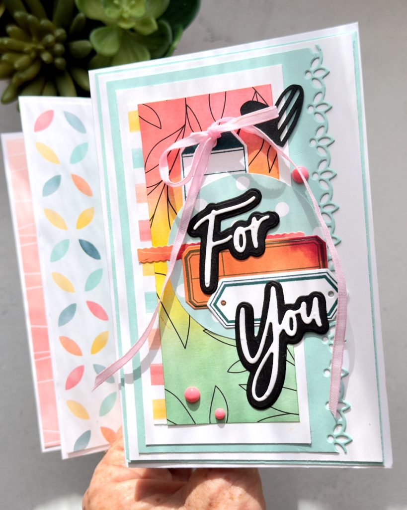 Handmade “For You” card created with the Stampin’ Up! Beautiful Ordinary Life Suite featuring blended Pool Party, Flirty Flamingo and Daffodil Delight backgrounds, layered die cuts, black script sentiments, pink ribbon bow and decorative floral accents.